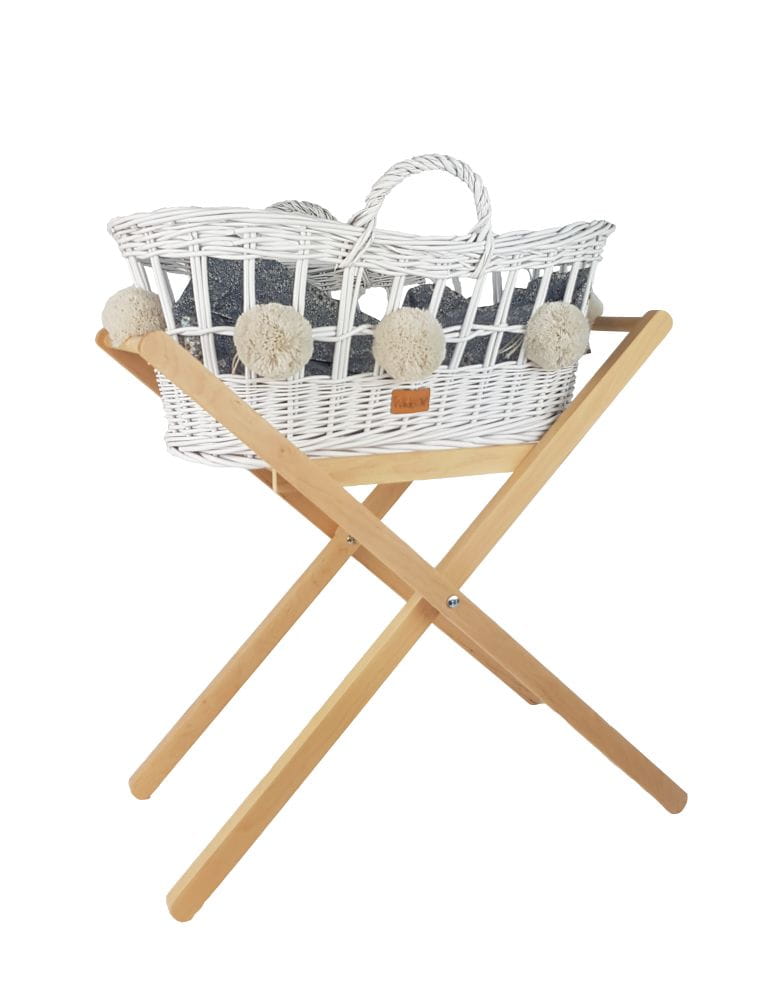 A WHITE WICKER MOSES BASKET FOR DOLLS ON A FRAME